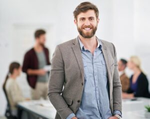 portrait of a young businessman in an office with team